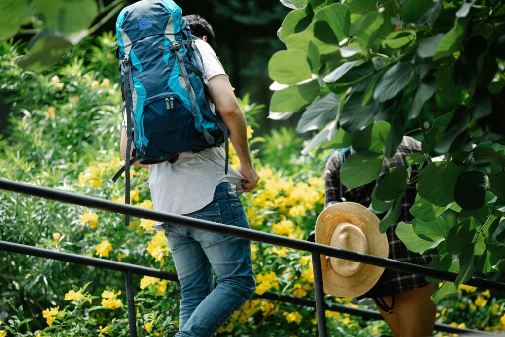 Woman in Blue Denim Jeans Carrying a Blue Backpack